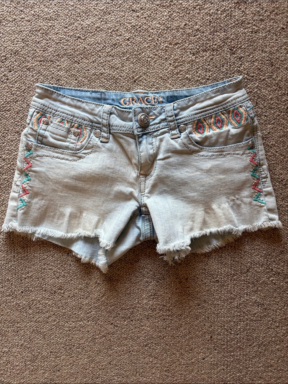 Grace in LA light blue denim shorts with colorful embroidery